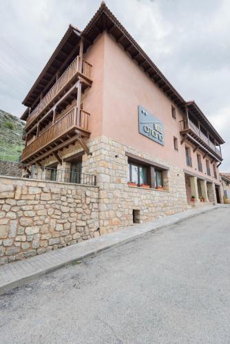 a building with a balcony on the side of it at Hotel Atiana in Albarracín