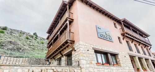 a building with a clock on the side of it at Hotel Atiana in Albarracín