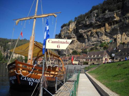 a boat docked at a dock with a sign on it at La ferme de Bousserand in Pontours