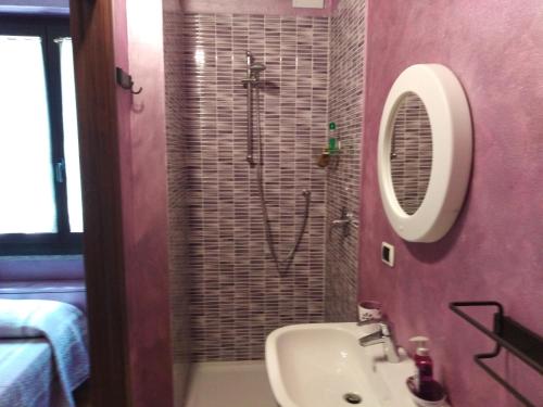 a bathroom with a sink and a shower at B&B Villa Anita in Bellano