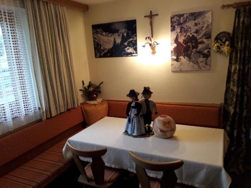 a room with a table with two figurines on it at Nieslerhof in Mayrhofen
