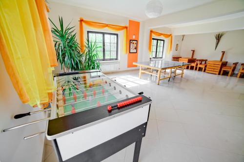 a living room with a foosball table in it at VILLA MEDICA - Ośrodek wypoczynkowy z basenem oraz pełnym wyżywieniem in Rabka