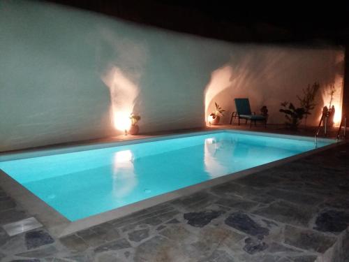a large swimming pool in a room with at Pyrgos in Mochlos