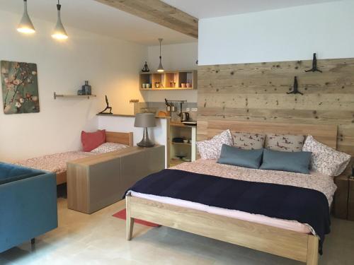 a bedroom with a bed with a wooden wall at Pension Andante in Špindlerův Mlýn