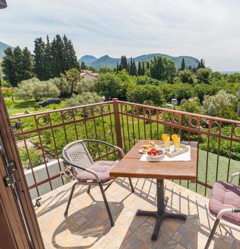 a table with a bowl of fruit on a balcony at Apartments Viktorija in Petrovac na Moru