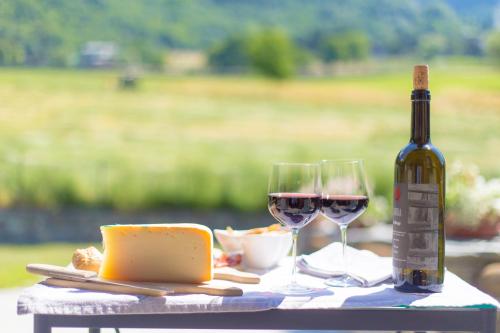 a table with two glasses of wine and cheese at VillAmour Boutique Hotel & SPA in La Salle