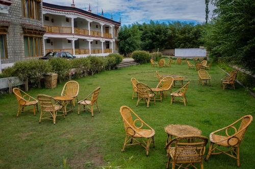 a group of chairs and tables in a yard at The Nature Residency - A Riverside Resort in Leh in Leh