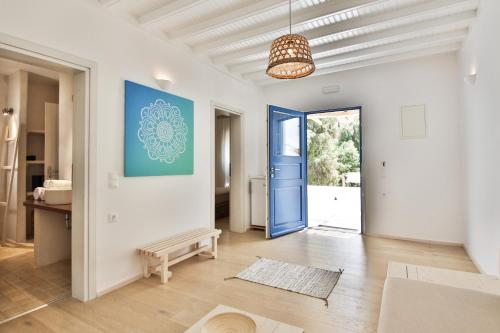 a large living room with a blue door at Baba Houlakia in Houlakia