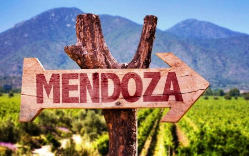 a wooden sign with the word mendota on a pole at Hotel Puerta del Sol in Mendoza