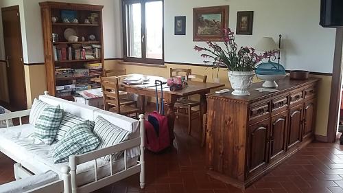 a living room with a table and a dining room at Casaletto In Maremma a Magliano in Magliano in Toscana
