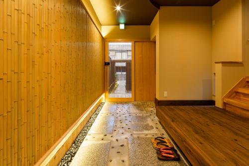 an empty room with a hallway with wooden floors at Hisashi in Kyoto