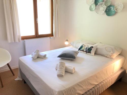 タロワールにあるAngel Services - Le Vivierのベッドルーム1室(白いベッド1台、タオル付)