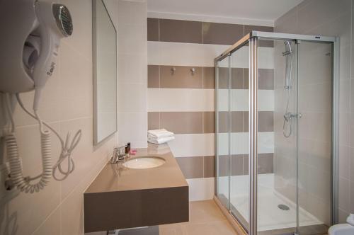 a bathroom with a shower and a sink at Hotel Jávea in Jávea