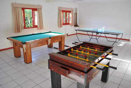 two ping pong tables in a room with at Residencial Sol e Mar de Floripa in Florianópolis