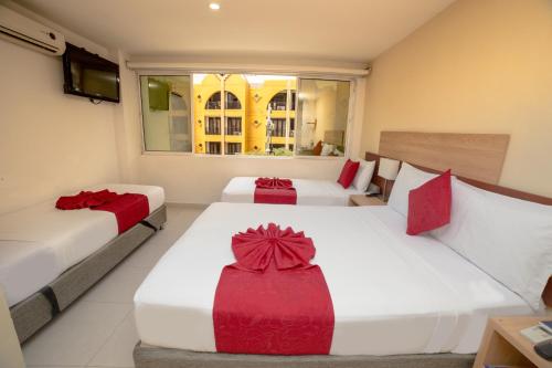 Una cama o camas en una habitación de Hotel Portobahia Santa Marta Rodadero