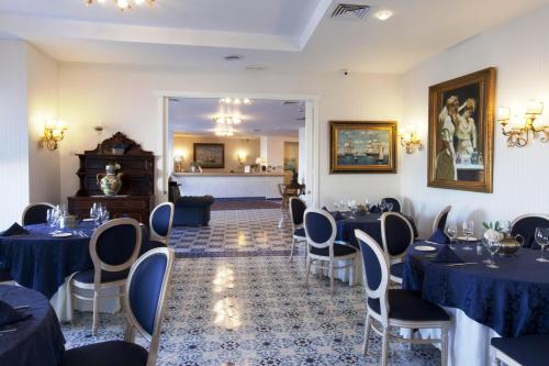 a banquet room with blue tables and chairs at Punta Campanella Resort & Spa in Massa Lubrense