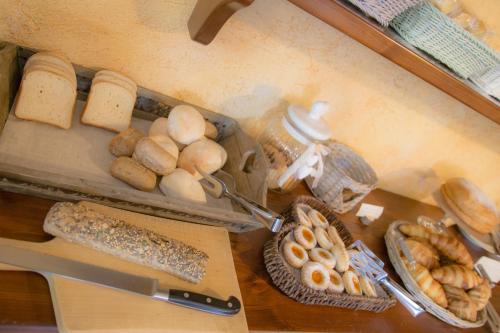 a table with bread and other food items on it at VillAmour Boutique Hotel & SPA in La Salle