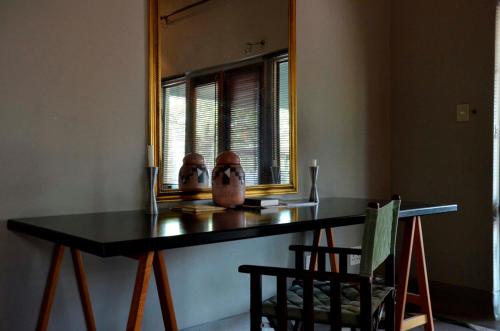 a table in a room with a mirror at Tingala Lodge - Bed in the Bush in Phalaborwa
