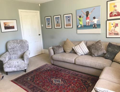 a living room with a couch and a chair at The Old Rectory,Nr Silverstone in Towcester