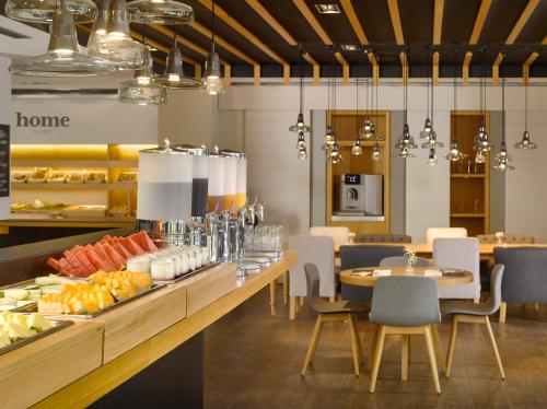 a restaurant with a buffet of food on a table at INNSiDE by Meliá Prague Old Town in Prague