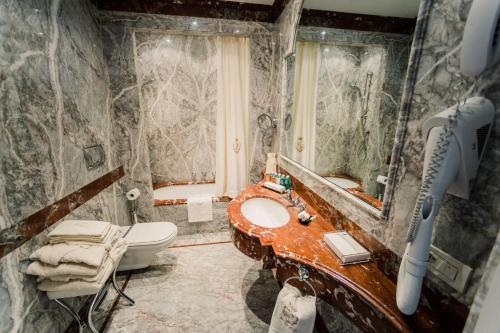
a bathroom with a sink and a bath tub at Versilia Golf Resort in Forte dei Marmi
