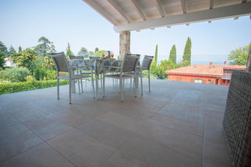 a table and chairs sitting on a patio at Italianflat - Maison du Lac in Lazise