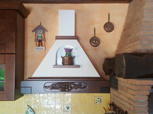 a kitchen with a stove with a flower pot on it at La Casetta in Fiera (Fiera di Roma) in Casale Malnome