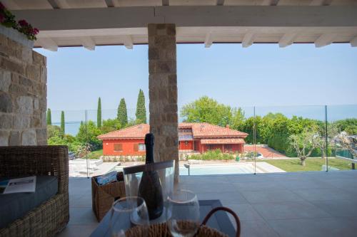 a patio with a table and a view of a house at Italianflat - Maison du Lac in Lazise