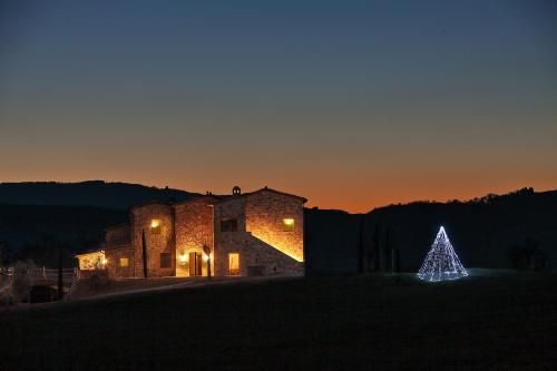 a lit christmas tree in front of a building at RELAIS VAL D'ORCIA in Pienza