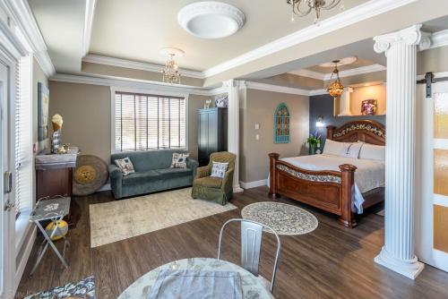 a bedroom with a bed and a living room at Brookside Inn Boutique Hotel in Abbotsford