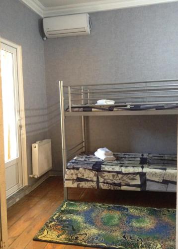 a room with two bunk beds and a rug at Nika7 in Tbilisi City
