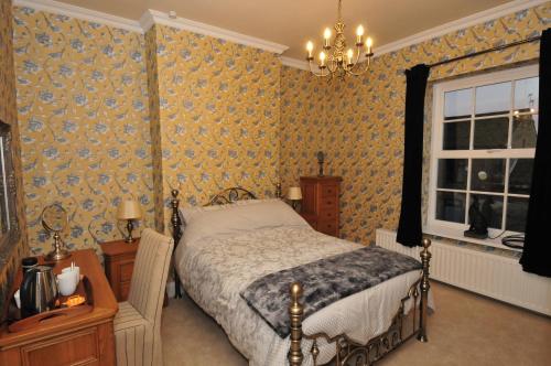 a bedroom with a bed and a window at Ashtree House Bed and Breakfast in Thornton
