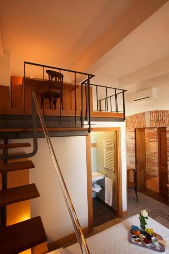a room with a loft with a staircase and a living room at CampuSpace in Cagliari