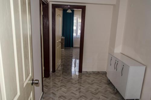 a hallway with an open door leading to a room at Çanakkale Venüs Pansiyon in Canakkale
