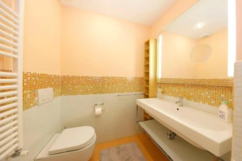 a bathroom with a toilet and a sink at Siena UpTown - Sabrina's Cozy Apartment in Siena