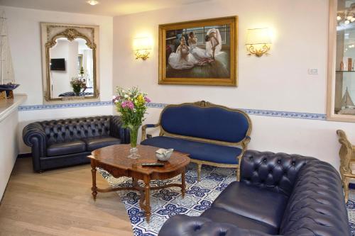 a living room with a couch and a table at Punta Campanella Resort & Spa in Massa Lubrense