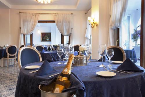 a bottle of champagne sitting on a table in a restaurant at Punta Campanella Resort & Spa in Massa Lubrense
