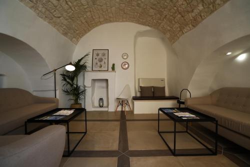 a living room with two couches and two tables at GH Dimora Sant'Anna in Carovigno