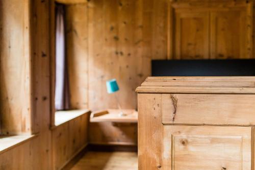 a wooden room with a table and a lamp at Josephus in Senales