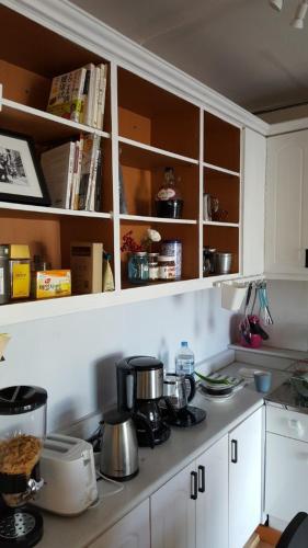 a kitchen with white cabinets and pots and pans at The Guesthouse DMZ Stay in Paju