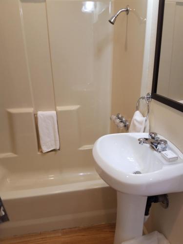 a bathroom with a sink and a toilet and a tub at Shoshone Inn in Shoshone