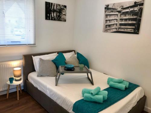 a bedroom with a bed with a table on it at Upper Highview - Self Catering Apartment, fpventures Stroud in Stroud