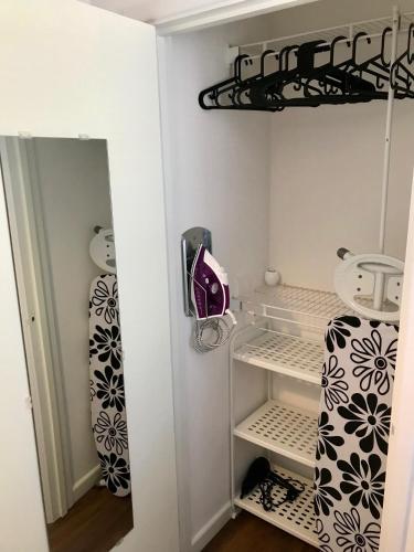 a walk in closet with white walls and black and white curtains at Upper Highview - Self Catering Apartment, fpventures Stroud in Stroud