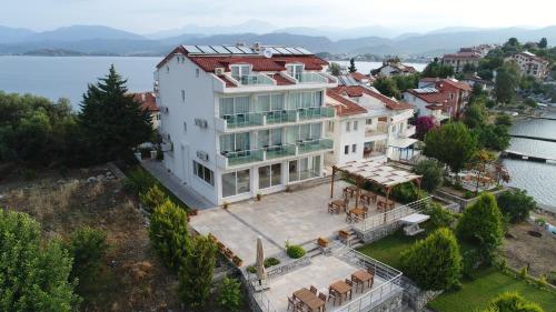 an aerial view of a house on the water at Sovalye Hotel in Fethiye