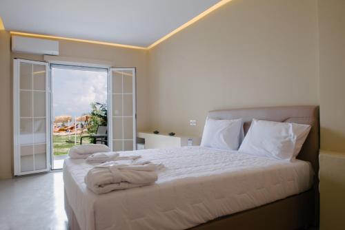 a bedroom with a bed with towels on it at Argilos in Sidari