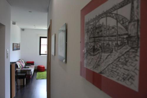a hallway with a living room with a drawing on the wall at Casa Viriato in Santa Maria Da Feira