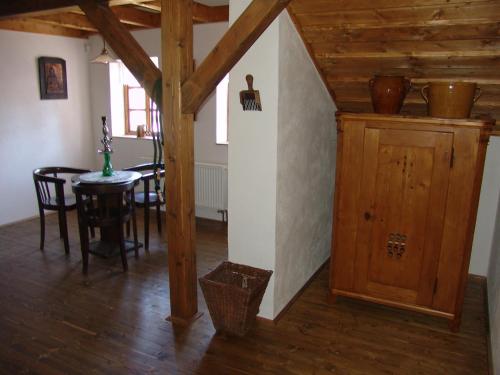 a dining room with a table and a wooden ceiling at Penzion Olesnice in Zlatá Olešnice