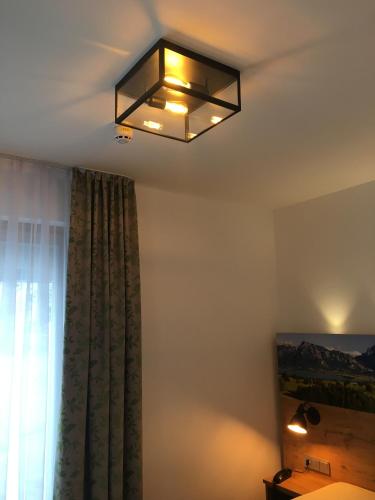 a light hanging from the ceiling in a room at Parkhotel Leiser in Planegg