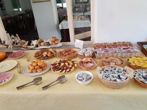 a table with many different types of food on it at Albergo Lungomare in Bonassola