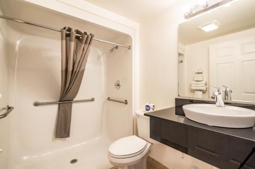 a bathroom with a white toilet and a sink at Motel 6-Rigby, ID in Lorenzo